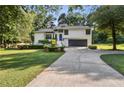 Charming home with a long driveway, well-kept lawn, and lush greenery surrounding the property at 2010 Barnes Mill Rd, Marietta, GA 30062