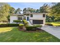 Well-maintained two-story home with manicured landscaping, gray garage door, and inviting curb appeal at 2010 Barnes Mill Rd, Marietta, GA 30062