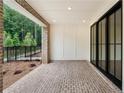 Covered patio with brick floors, white paneling, and large sliding doors offering an outdoor living space at 340 Olmstead Way # 34, Alpharetta, GA 30022