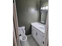 Charming half bath featuring modern vanity, black hardware and a modern toilet at 5400 Louis Xiv Ln, Atlanta, GA 30349