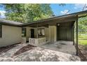 Charming brick home with a covered entryway and attached carport on a sunny day at 5400 Louis Xiv Ln, Atlanta, GA 30349