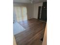 Open-concept living room showcasing wood laminate flooring, brick fireplace, and natural light at 5400 Louis Xiv Ln, Atlanta, GA 30349