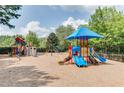 Community playground featuring slides, climbing structures, and a shaded seating area at 7204 Eton Ln, Locust Grove, GA 30248