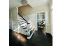 Bright foyer with dark wood floors, elegant staircase, chandelier, and access to a sitting area at 3201 Palisades Se Ct, Marietta, GA 30067