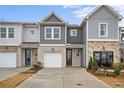 View of the new two-story townhomes with gray and stone facades, single-car garages, and landscaped front yards at 514 Crown Dr, Emerson, GA 30137