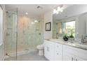 Modern bathroom featuring a glass-enclosed shower, double vanity, and marble accents at 1272 Hardee Ne St, Atlanta, GA 30307