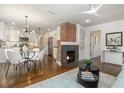 Bright living room with a fireplace, modern lighting, and an open floor plan leading to the kitchen at 1272 Hardee Ne St, Atlanta, GA 30307