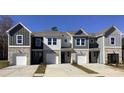 Multiple townhomes with neutral-toned siding, brick foundations, and private garages at 510 Crown Dr, Emerson, GA 30137