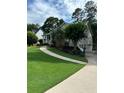 Charming home with lush green lawn, curved walkway and driveway plus manicured landscaping at 60 Stonehedge Dr, Buford, GA 30518