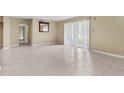 Open living room with a sliding glass door offering natural light and outdoor views at 115 Camelot Dr, Atlanta, GA 30349