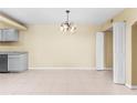 Open living area with unique chandelier and doorway providing access to additional space at 115 Camelot Dr, Atlanta, GA 30349