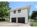 Shot of the side of the house, featuring white painted brick and black garage doors at 1894 Twin Falls Rd, Decatur, GA 30032