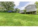 Lush backyard featuring a large grassy area, mature trees, and a play area for outdoor fun at 4856 Habersham Sw Rdg, Lilburn, GA 30047