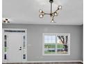 Bright living room featuring a modern chandelier and a minimalist design at 5195 Oaks Landing Ct, Sugar Hill, GA 30518