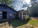 Home with a covered porch and patriotic decor at 6733 Old Covington Rd, Lithonia, GA 30058