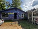 Single-story home with light blue siding and barred windows at 6733 Old Covington Rd, Lithonia, GA 30058