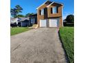 Two-story home with a driveway and front yard at 842 Shoals Ct, Atlanta, GA 30349