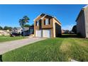 Inviting two-story home with a spacious driveway and well-maintained lawn at 842 Shoals Ct, Atlanta, GA 30349
