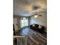 Comfortable living room with hardwood floors, ceiling fan, and natural light at 842 Shoals Ct, Atlanta, GA 30349