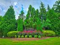 The Farris Community is an eye-catching sight with green trees, flower beds, and manicured shrubbery at 171 Shaker Hollow Drive Dr, Mcdonough, GA 30253