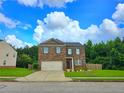 Charming two-story brick home with a well-manicured lawn and a two-car garage at 171 Shaker Hollow Drive Dr, Mcdonough, GA 30253