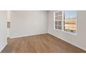 Bright, empty room with wood floors, white walls, baseboard trim and a large window at 237 Arwen Drive Lot 61, Mcdonough, GA 30252