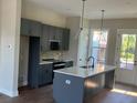Modern kitchen boasts sleek gray cabinets, an island, and stainless steel appliances at 970 Bibbs Circle Nw # 12, Atlanta, GA 30318