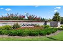 Stone community entrance sign displaying vibrant landscaping and the Independence neighborhood name at 255 Silver Moon Dr, Loganville, GA 30052