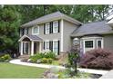 Beautifully landscaped front yard with colorful flowers, stone accents, and a welcoming entrance at 4249 Arbor Club Dr, Marietta, GA 30066