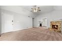 Spacious living room with neutral carpet, stone fireplace and ceiling fan, perfect for gatherings at 536 Cherokee Overlook Court Ct, Canton, GA 30115