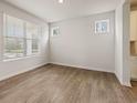 Spacious living room with wood floors and natural light from windows with views at 609 Elsa Lane Lot 76, Mcdonough, GA 30252