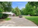 Long concrete driveway leading to a detached garage, with ample parking space for multiple vehicles at 145 Deep Step Rd, Covington, GA 30014