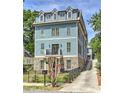 Charming three-story home with blue siding, stone accents, and a well-maintained front yard at 2972 Lookout Ne Pl, Atlanta, GA 30305