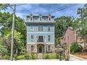 Charming three-story home with blue siding, stone accents, and a well-maintained front yard at 2972 Lookout Ne Pl, Atlanta, GA 30305