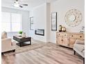 Inviting living room showcasing an electric fireplace, stylish furnishings, neutral colors, and lots of natural light at 541 Fundao Ln, Lawrenceville, GA 30046