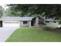 Lovely single-story house displaying stone accents, a welcoming front yard, and an attached two-car garage at 6878 Vic Ar Rd, Atlanta, GA 30360