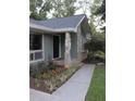 Beautiful home exterior with a stone-accented porch, stylish front door, and colorful garden at 6878 Vic Ar Rd, Atlanta, GA 30360