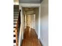 Hallway with wooden floors and multiple doors offers access to rooms in the home at 1870 Garbrooke, Lawrenceville, GA 30046