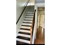 Carpet free staircase with wood treads and painted risers lead to the upper level of the home at 1870 Garbrooke, Lawrenceville, GA 30046