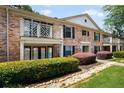 Well-maintained brick condo building with mature landscaping and private balconies at 3650 Ashford Dunwoody Ne Rd # 413, Atlanta, GA 30319