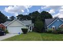 Lovely home featuring a two-car garage, and a spacious front yard at 20 Bacchus Dr, Lawrenceville, GA 30045