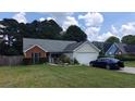 Charming single-story home with a well-manicured lawn, a screened porch, and an attached two-car garage at 20 Bacchus Dr, Lawrenceville, GA 30045