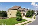 Two story home with a manicured lawn and a long driveway on a sunny day at 253 Orchard Trl, Holly Springs, GA 30115