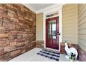 A close-up view of the front door with stone accents for a great curb appeal at 253 Orchard Trl, Holly Springs, GA 30115