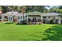 Expansive backyard featuring a covered patio, stone accents, and ample green space at 263 Mountainview Cir, Canton, GA 30115