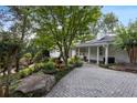 Paved driveway leading to a white house surrounded by lush landscaping at 263 Mountainview Cir, Canton, GA 30115