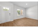 Bright entryway features wood-look floors, a white door, and windows that provide natural light at 342 Orwell Drive Lot 95, Social Circle, GA 30025