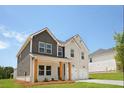 Charming two-story home boasts a painted brick facade and an attached two-car garage at 342 Orwell Drive Lot 95, Social Circle, GA 30025
