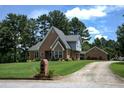 Charming brick home with a well-manicured lawn and mature trees in a peaceful setting at , Stockbridge, GA 30281