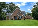 Charming brick home with a well-manicured lawn and mature trees in a peaceful setting at , Stockbridge, GA 30281